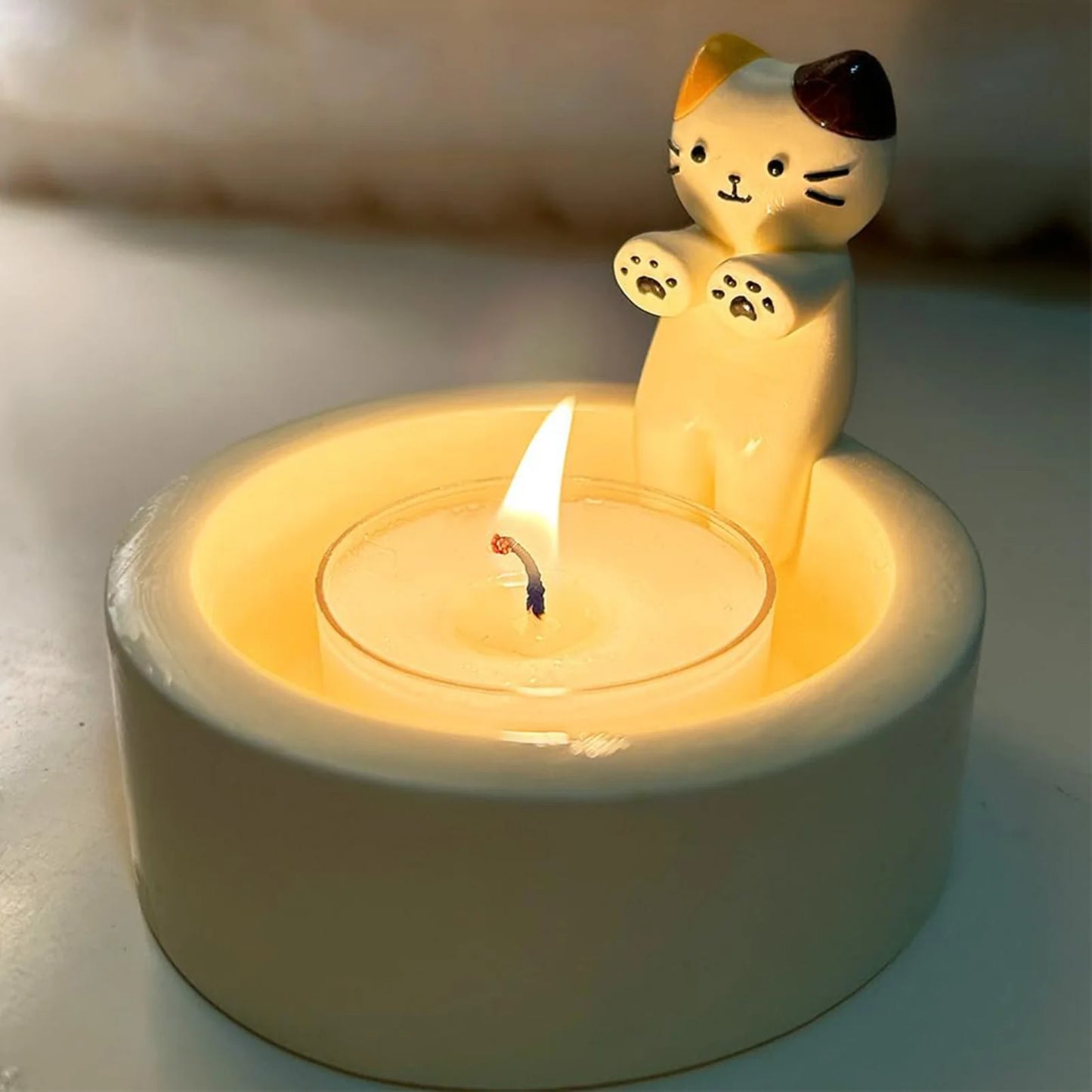 Kitten Candle Holder Warming Its Paws from odditygadget at $9.99